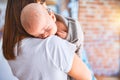 Young beautifull woman and her baby standing on the floor at home Royalty Free Stock Photo