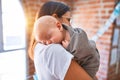 Young beautifull woman and her baby standing on the floor at home Royalty Free Stock Photo