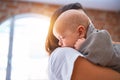 Young beautifull woman and her baby standing on the floor at home Royalty Free Stock Photo