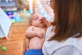 Young beautifull woman and her baby standing on the floor at home Royalty Free Stock Photo