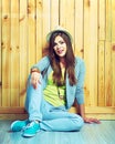 Young beautifull woman in hipster youth style sitting on a floo Royalty Free Stock Photo