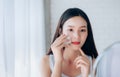 Young Beauty Asian Woman Cleaning Face with Cotton Royalty Free Stock Photo