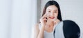 Young Beauty Asian Woman Cleaning Face with Cotton Her Looking at Mirror Royalty Free Stock Photo