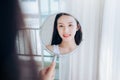 Young Beauty Asian Woman Looking at Mirror Check Clear Face Royalty Free Stock Photo