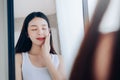 Young Beauty Asian Woman Looking at Mirror Check Clear Face Skincare Royalty Free Stock Photo