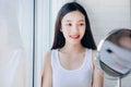 Young Beauty Asian Woman Looking at Mirror Check Clear Face Royalty Free Stock Photo