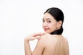 Young beauty Asian woman turning smiling face and showing bare back isolated over white background Royalty Free Stock Photo