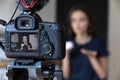 Young beauty blogger girl recording video on dslr camera Royalty Free Stock Photo