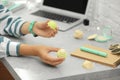 Young beauty blogger with lip balm at grey marble table, closeup