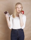 Young beauty blond teenage girl eating chocolate Royalty Free Stock Photo