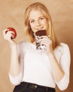 Young beauty blond teenage girl eating chocolate Royalty Free Stock Photo