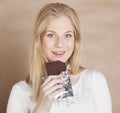 Young beauty blond teenage girl eating chocolate Royalty Free Stock Photo