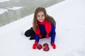 The young beauty the blonde placed red apples on snow. Royalty Free Stock Photo