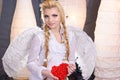 Young beauty girl angel holding the heart Royalty Free Stock Photo