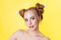 Young beauty girl with hair horns electic lamp hairstyle on a yellow background