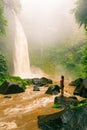 Young beauty woman enjoy spectacular morning view, beautiful Nungnung Waterfall, Bali Royalty Free Stock Photo