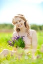 Young beauty smiling woman in the field, on the grass. Girl rest Royalty Free Stock Photo