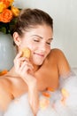 Young beauty woman in the bath washing her face Royalty Free Stock Photo