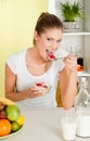 Young beauty woman eating cereal with strawberry Royalty Free Stock Photo