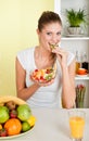 Young beauty woman eating fruit salad Royalty Free Stock Photo