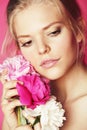 Young beauty woman with flower peony pink closeup makeup soft tender gentle look Royalty Free Stock Photo