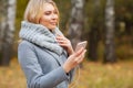 Young Beauty woman listening music in autumn forest Royalty Free Stock Photo