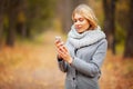 Young Beauty woman listening music in autumn forest Royalty Free Stock Photo