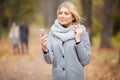 Young Beauty woman listening music in autumn forest Royalty Free Stock Photo