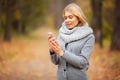 Young Beauty woman listening music in autumn forest Royalty Free Stock Photo