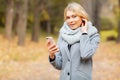 Young Beauty woman listening music in autumn forest Royalty Free Stock Photo