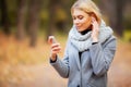 Young Beauty woman listening music in autumn forest Royalty Free Stock Photo