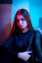 Young beauty woman posing over night city dramatic red and blue neon Royalty Free Stock Photo