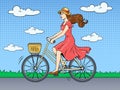 Young woman ride on bicycle pop art vector