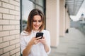 Pretty young woman use cellphone in city Royalty Free Stock Photo