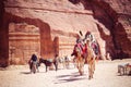 Young Bedouin and boy Bedouin are riding camels Royalty Free Stock Photo