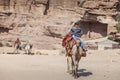 Young bedouin riding a camel Royalty Free Stock Photo