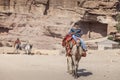 Young bedouin riding a camel