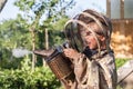 Young beekeeper boy using a smoker on bee yard Royalty Free Stock Photo