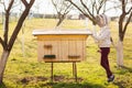 A young beekeeper girl is working with bees and beehives on the apiary Royalty Free Stock Photo
