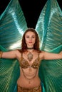 Young belly dancer posing with Isis wings