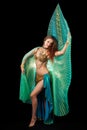 Young belly dancer posing with Isis wings