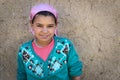 Young Berber girl poses in front of her home in a small Berber village in the Ziz Valley, near Errachidia, Morocco