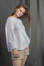 Young sporty girl in white blouse resting on a bench