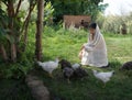 Girl feeding chickens in the garden