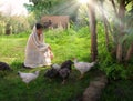 Girl feeding chickens in the garden