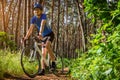 Young bicyclist riding in the forest