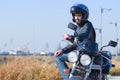 Young biker on his motorcycle and helmet