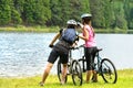 Young bikers at lake watching the forest Royalty Free Stock Photo