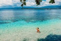 Young bikini woman relax in blue ocean on tropical island