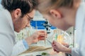 Biologists with wheat ear in lab Royalty Free Stock Photo